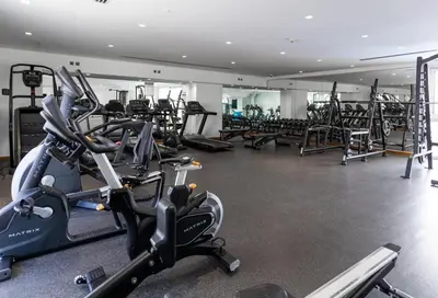 a gym with several treadmills and cardio machines at Marina Residences 2BR: Seaside in Palm Jumeirah in Dubai