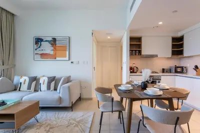 a living room with a table and a couch at Vacationer l 1 Bedroom on Low Floor l Close to Burj Khalifa l Pool Access & Free Wi-Fi in Dubai