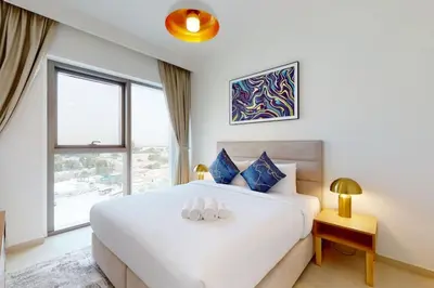 a bedroom with a white bed and a window at Vacationer l 1 Bedroom on Low Floor l Close to Burj Khalifa l Pool Access & Free Wi-Fi in Dubai
