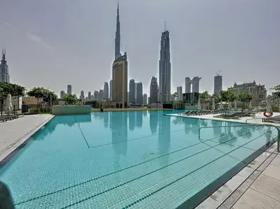 a large swimming pool with a city skyline in the background at Vacationer l 1 Bedroom on Low Floor l Close to Burj Khalifa l Pool Access & Free Wi-Fi in Dubai