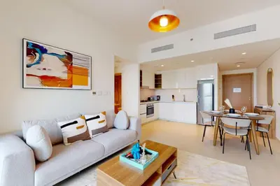a living room with a couch and a table at Vacationer l 1 Bedroom on Low Floor l Close to Burj Khalifa l Pool Access & Free Wi-Fi in Dubai