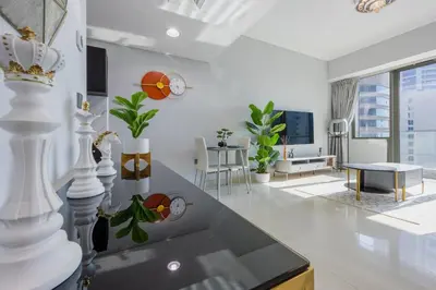 a large white living room with a dining room at Ocean Heights - Gorgeous One Bedroom in Dubai