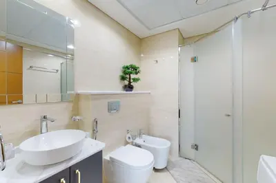 a bathroom with a sink and a toilet and a shower at Ocean Heights - Gorgeous One Bedroom in Dubai