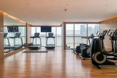 a gym with treadmills and exercise equipment in a building at Frank Porter - Carson A in Dubai