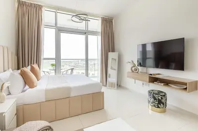 a bedroom with a large bed and a large window at Frank Porter - Carson A in Dubai