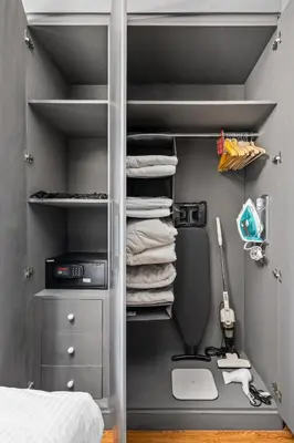 a bedroom with a closet with a desk and towels at Luxury studio at JLT near metro in Dubai