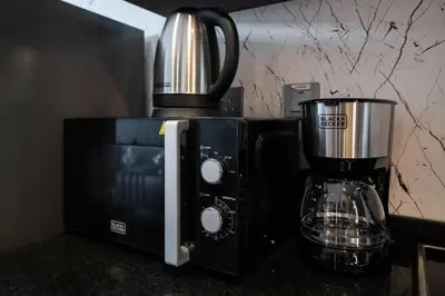 a coffeemaker sitting on a counter next to a blender at Luxury studio at JLT near metro in Dubai