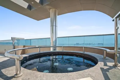 a hot tub on the roof of a building at Stylish studio at Sports City in Dubai