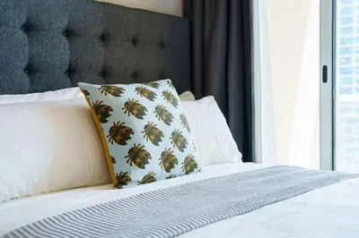 a bed with a pillow on top of it at Upscale studio at JLT near metro in Dubai