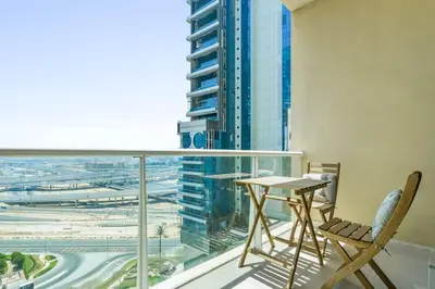 a balcony with a table and chair and a view of a city at Upscale studio at JLT near metro in Dubai