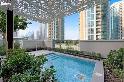 a swimming pool on the roof of a building with tall buildings at bnbme - Luxury 1BR Apt w Burj Khalifa Views Pool Gym & Prime Location Near Dubai Mall in Dubai