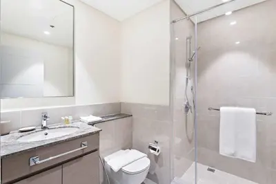 a bathroom with a shower and a toilet and a sink at Silkhaus Opera district in Downtown new tower with pool & gym in Dubai