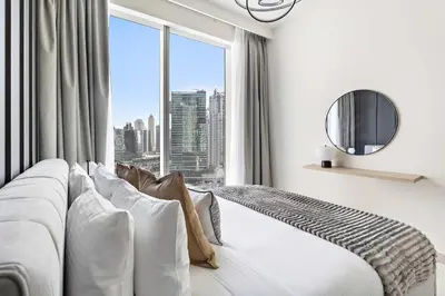 a bedroom with a bed with a large window at Silkhaus Opera district in Downtown new tower with pool & gym in Dubai