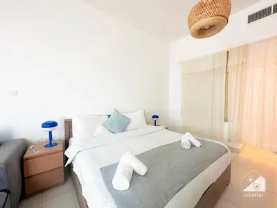 a bedroom with a bed with two towels on it at Stunning Palm Views Apt on the beach Dubai in Dubai