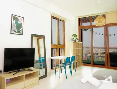 a living room with a television and a table and chairs at Stunning Palm Views Apt on the beach Dubai in Dubai