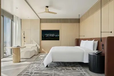 a bedroom with a white bed and a bathroom at SIRO One Za'abeel in Dubai