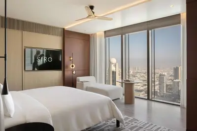 a bedroom with a white bed and a large window at SIRO One Za'abeel in Dubai