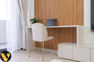 a white chair sitting in front of a desk with a laptop at Vogue Downtown Act Two near Burj Khalifa and Dubai Mall, Three Bedroom Plus Kids room Apartment with Balcony and Burj Khalifa View, Access to all Amenities in Dubai