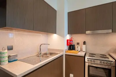 a kitchen with a sink and a stove at INA Homes - Act 1 Full Burj Khalifa and Fountain Views in Dubai