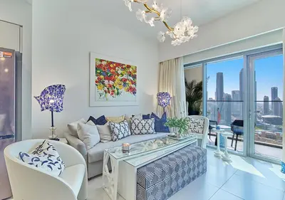 a living room with a couch and a table at FIRST CLASS 2BD, Full Burj Khalifa view in the Heart of Downtown in Dubai