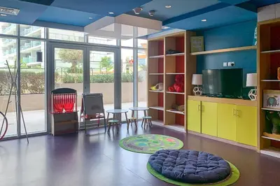 a living room with a blue ceiling and a room with a tv at Frank Porter - Majestine 1 in Dubai