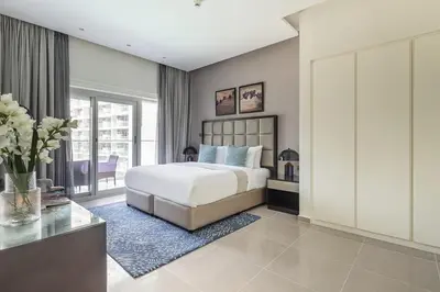 a bedroom with a white bed and a large window at Frank Porter - Majestine 1 in Dubai