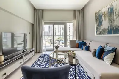 a living room with a couch and a tv at Frank Porter - Majestine 1 in Dubai