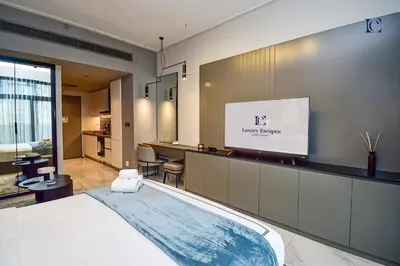 a hotel room with a bed and a flat screen tv at Luxury Escapes - Large & Brand New Studio Apt Business Bay - MAG in Dubai