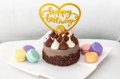 a chocolate cake with a heart and a happy birthday sign at Quasi-Hotels Zada Cozy Lux in Business Bay 1BR in Dubai