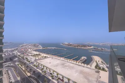 an aerial view of a city with a harbor at Elegant seaside living 3-bedroom Emaar Beachfront by Suiteable in Dubai