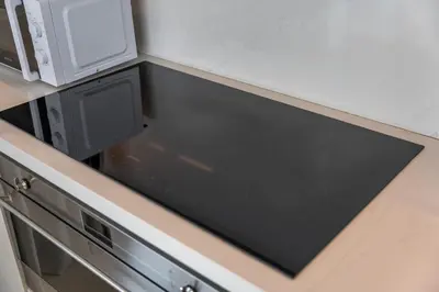 a microwave oven sitting on top of a kitchen counter at Elegant seaside living 3-bedroom Emaar Beachfront by Suiteable in Dubai