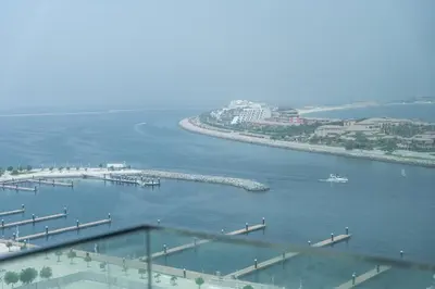 an aerial view of a harbor with a boat in the water at Elegant seaside living 3-bedroom Emaar Beachfront by Suiteable in Dubai