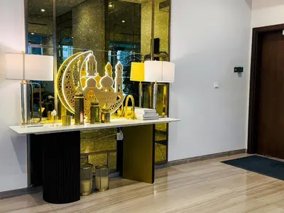 a lobby with a table with a large gold exhibit at Cozy 1 BR in Business Bay Dubai by GP Holiday Homes in Dubai