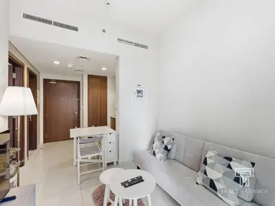 a living room with a couch and a table at Cozy 1 BR in Business Bay Dubai by GP Holiday Homes in Dubai