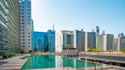 a pool in a city with tall buildings at Luxurious Studio in Business Bay by Tanami Holiday Homes in Dubai
