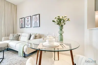 a living room with a glass table and a couch at Pristine 1BR at Binghatti Creek Al Jadaf by Deluxe Holiday Homes in Dubai