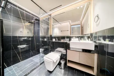 a bathroom with a toilet and a sink and a shower at Pristine 1BR at Binghatti Creek Al Jadaf by Deluxe Holiday Homes in Dubai