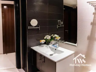 a bathroom with a sink and a mirror at The Urban Oasis - Bliss in Dubai