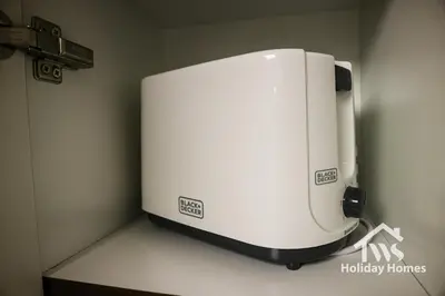 a white appliance sitting on a counter in a room at The Urban Oasis - Bliss in Dubai