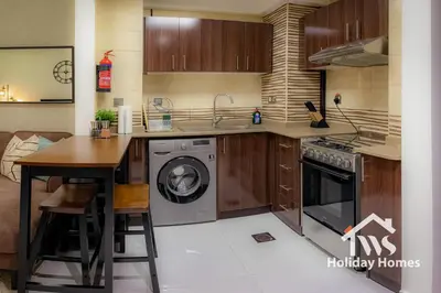 a kitchen with a washer and dryer in it at The Urban Oasis - Bliss in Dubai
