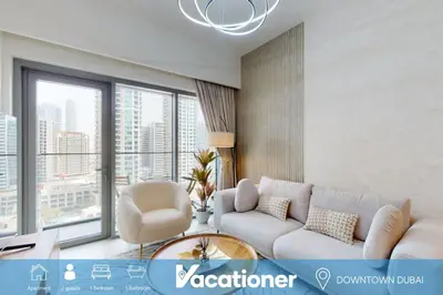 a living room with a couch and a chair at Burj Royale - Classic One Bedroom in Dubai