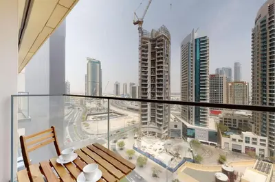 a balcony with a table and a view of a city at Burj Royale - Classic One Bedroom in Dubai
