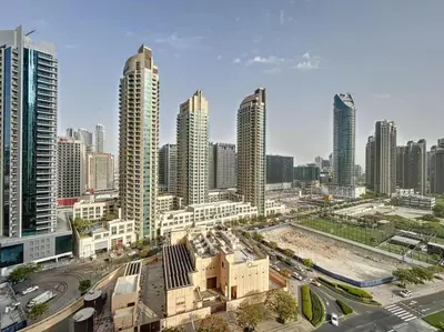 a city skyline with tall buildings and a street at Burj Royale - Classic One Bedroom in Dubai