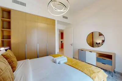 a bedroom with a large white bed and a mirror at Vacationer I Premium One Bed with Skyline Views I Summer Creek Beach Tower 2, Dubai Creek Harbour in Dubai