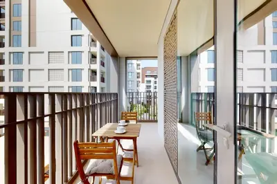 a balcony with a wooden table and chairs on it at Vacationer I Premium One Bed with Skyline Views I Summer Creek Beach Tower 2, Dubai Creek Harbour in Dubai