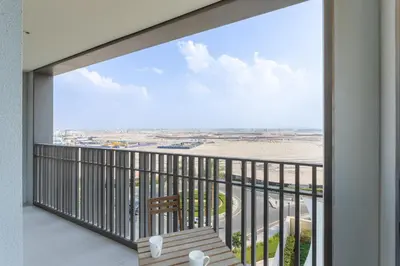 a balcony with a view of an airport at Vacationer I Premium One Bed with Skyline Views I Summer Creek Beach Tower 2, Dubai Creek Harbour in Dubai