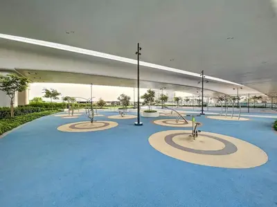 a large empty building with a blue floor and lights at Vacationer I Premium One Bed with Skyline Views I Summer Creek Beach Tower 2, Dubai Creek Harbour in Dubai