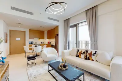 a living room with a white couch and a table at Vacationer I Premium One Bed with Skyline Views I Summer Creek Beach Tower 2, Dubai Creek Harbour in Dubai