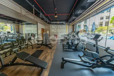 a gym with cardio equipment in a building at Le Petit Village !Cozy Yet Spacious Studio Apartment! in Dubai