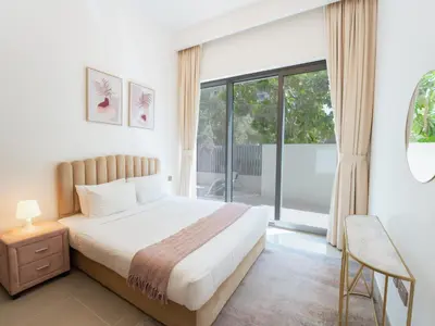 a bedroom with a bed and a large window at EasyGo - Exceptional 2BDR- Large Terrace-Pool Access in Dubai
